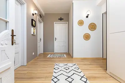 a hallway with a white door and a rug at Kapana Guest House on Central Pedestrian street with Parking included in Plovdiv