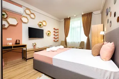 a bedroom with a bed and a desk and a television at Kapana Guest House on Central Pedestrian street with Parking included in Plovdiv
