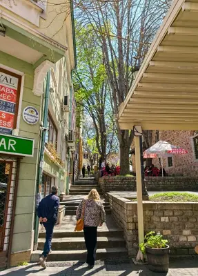a couple of people walking down the steps of a building at 4 Rooms in Plovdiv