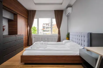 a bedroom with a large white bed and a window at The Honeycomb Hideaway by Flat Mаnager in Sofia