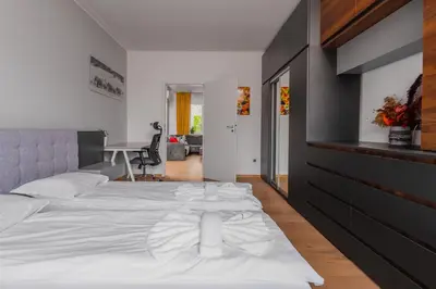 a bedroom with a white bed and a desk at The Honeycomb Hideaway by Flat Mаnager in Sofia