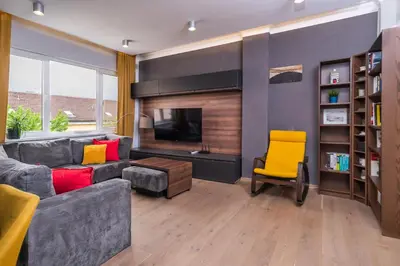a living room with a gray couch and a yellow chair at The Honeycomb Hideaway by Flat Mаnager in Sofia