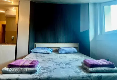 a bedroom with a bed with two pillows on it at Easy rooms in Sofia