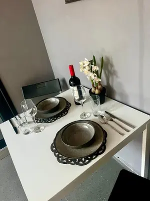 a table with two plates and wine glasses on it at Easy rooms in Sofia