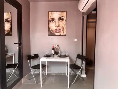 a dining room with a white table and chairs at Easy rooms in Sofia