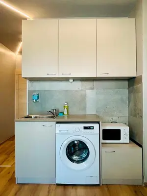 a kitchen with a washing machine and a sink at Easy rooms in Sofia