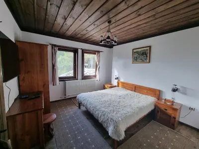 a bedroom with a bed and a wooden ceiling at Leshten Valentin's House in Leshten