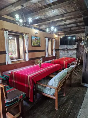 a dining room with two tables with red table cloth at Leshten Valentin's House in Leshten