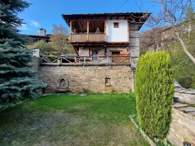 an old building with a balcony on top of it at Leshten Valentin's House in Leshten