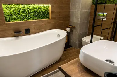 a bathroom with a white bath tub and a toilet at Какао Апартамент Велинград in Velingrad