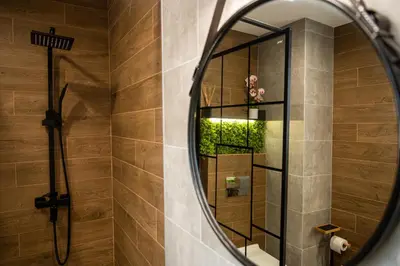 a bathroom with a mirror and a shower at Какао Апартамент Велинград in Velingrad