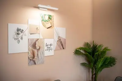 a bunch of pictures hanging on a wall at Какао Апартамент Велинград in Velingrad