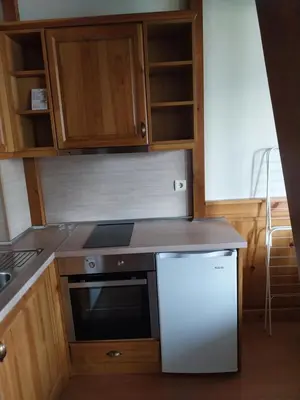 a kitchen with a stove and a white refrigerator at Piringolf apartment in Razlog