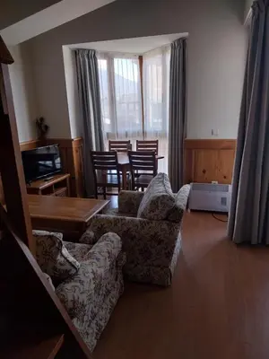 a living room with two couches and a table and chairs at Piringolf apartment in Razlog