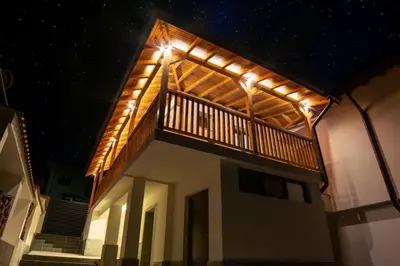 a house with a balcony with lights on it at Green Villa in Saparewo