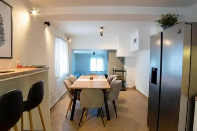 a kitchen and dining room with a table and chairs at Green Villa in Saparewo