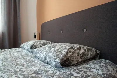 a bed with two pillows on top of it at Green Villa in Saparewo