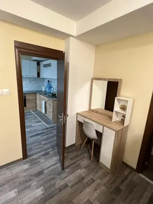 a room with a desk and a kitchen at Аpartment B201 Grand Bansko 1 in Bansko
