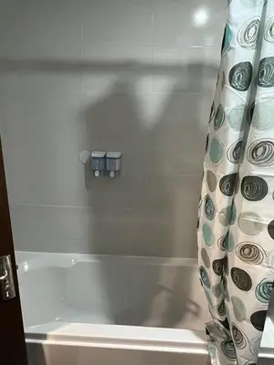 a bathroom with a tub and a shower curtain at Аpartment B201 Grand Bansko 1 in Bansko
