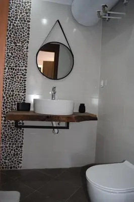 a bathroom with a sink and a mirror on the wall at Аpartment B201 Grand Bansko 1 in Bansko