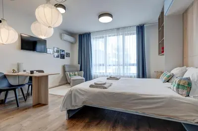 a bedroom with a bed and a desk and a table at New Studio - 300m Subway - 10 Mins City Centre in Sofia