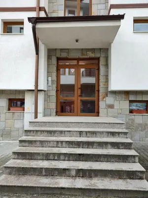 a set of stairs in front of a building with a door at Апартамент за гости Виктория in Chepelare