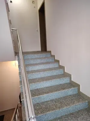 a staircase in a building with blue steps at Апартамент за гости Виктория in Chepelare