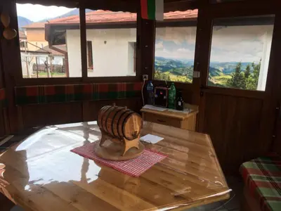 a wooden table with a hat on top of it at Белевската къща с беседка Belevska House with gazebo in Smolyan