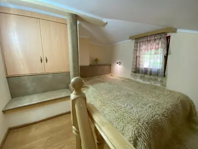 a bedroom with a bed and a window at Белевската къща с беседка Belevska House with gazebo in Smolyan