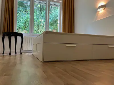 a desk with a chair in a room with windows at Opera Flat in Sofia