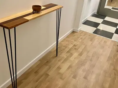 a wooden table in a room with a wooden floor at Opera Flat in Sofia