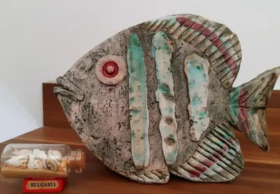 a fish statue sitting on top of a wooden table at Sofia Palms: Modern apartment with a large terrace in Sofia