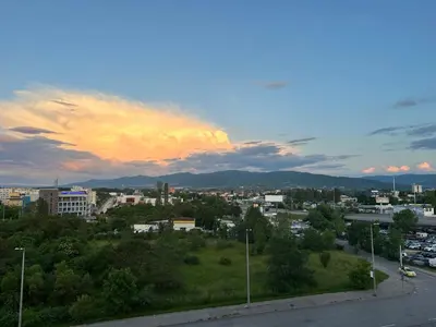 a view of a city with a sunset at INTER EXPO APARTMENT in Sofia