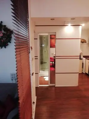 a room with a hallway with a living room at Sofia Zen - on Metro, ultra fast Wi-Fi in Sofia