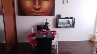 a room with a table and a picture on the wall at Sofia Zen - on Metro, ultra fast Wi-Fi in Sofia