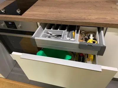 a kitchen counter with a drawer filled with kitchen utensils at Niko's deluxe apartment in Sofia