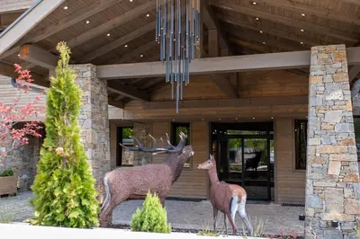 two deer statues standing in front of a house at Grande Vista Resort & Spa in Tsigov Chark