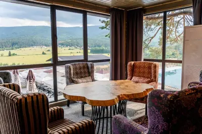 a room with a table and chairs and a large window at Grande Vista Resort & Spa in Tsigov Chark