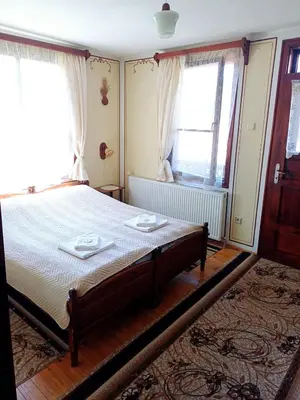 a bedroom with a bed with two plates on it at Guest Rooms Dona in Koprivshtitsa
