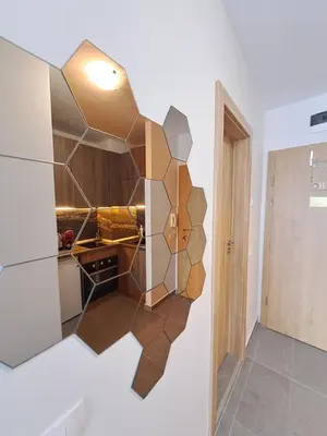a kitchen with a geometric design on the wall at Premium StudioApartment in Borovets Gardens in Borovets