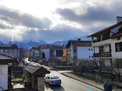 a city street with houses and a car on the road at View apartment #1 in Bansko