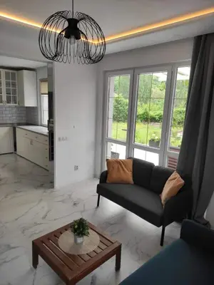 a living room with a couch and a table at Wellnesshouse Müller in Ilindentsi