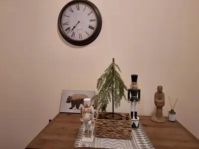 a table with figurines and a clock on a wall at Apartment in Bansko, very close to the Gondola in Bansko