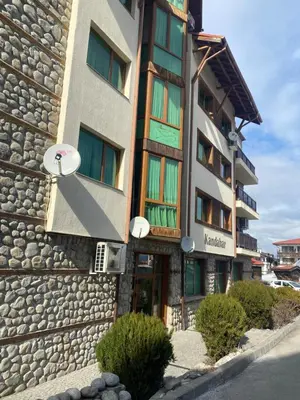 a building with a stone facade with a sign on it at Apartment in Bansko, very close to the Gondola in Bansko
