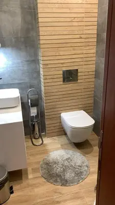 a bathroom with a toilet and a sink and a rug at 2 BED APARTMENT IN BANSKO RESORT in Bansko