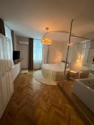 a bedroom with a bed with a chandelier at Luxury apartment with Jacuzzi in Sofia