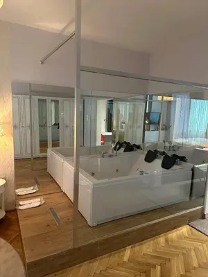 a large white bath tub in a room at Luxury apartment with Jacuzzi in Sofia
