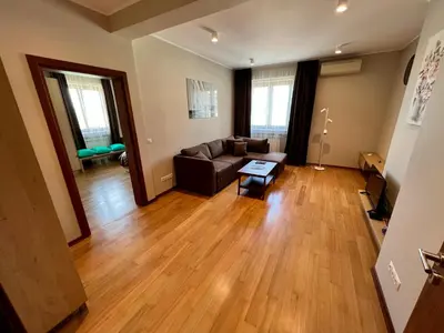 a living room with a couch and a table at LOCATION ! LOCATION ! LOCATION ! City Garden View Oak apartment in Sofia