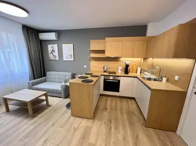 a kitchen with a table and a couch in a room at LOCATION ! Sofia Opera Apartment next to ALEXANDER NEVSKY CATHEDRAL in Sofia