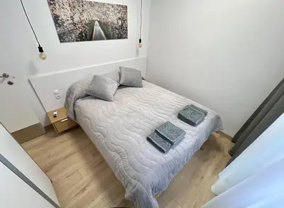 a small bedroom with a bed with two pillows on it at LOCATION ! Sofia Opera Apartment next to ALEXANDER NEVSKY CATHEDRAL in Sofia